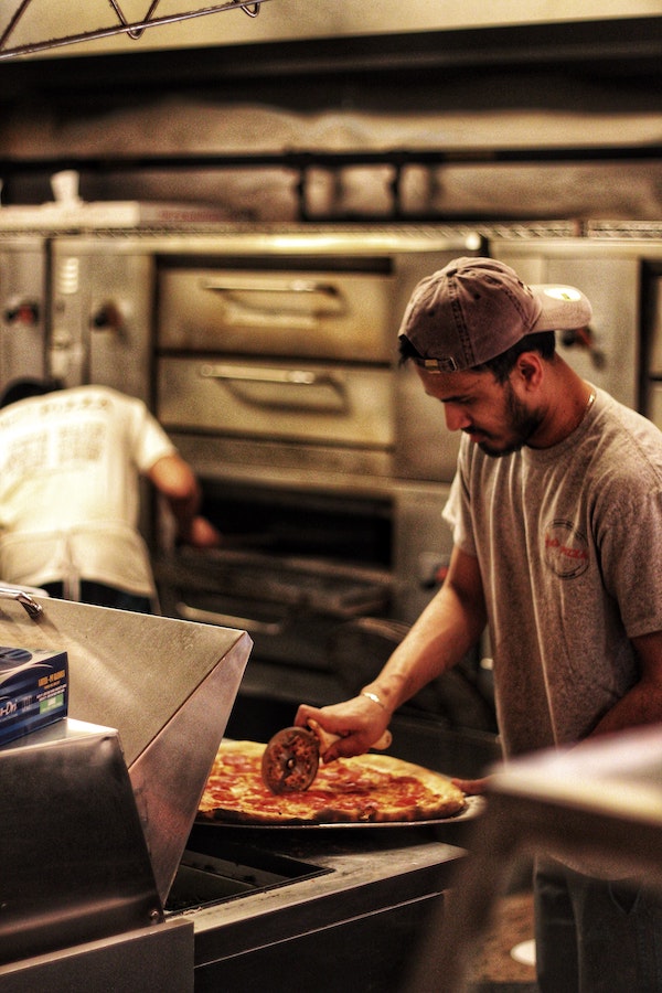 joe's pizza being cut at their broadway location | Better Together Here