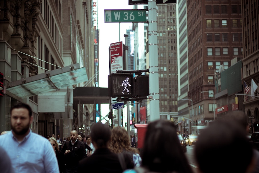 a walk sign on a busy street in new york city | Better Together Here