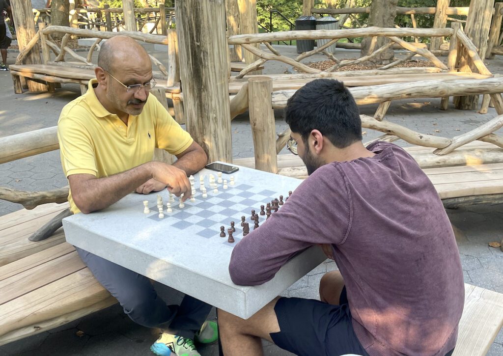 men playing chess in central park | Better Together Here