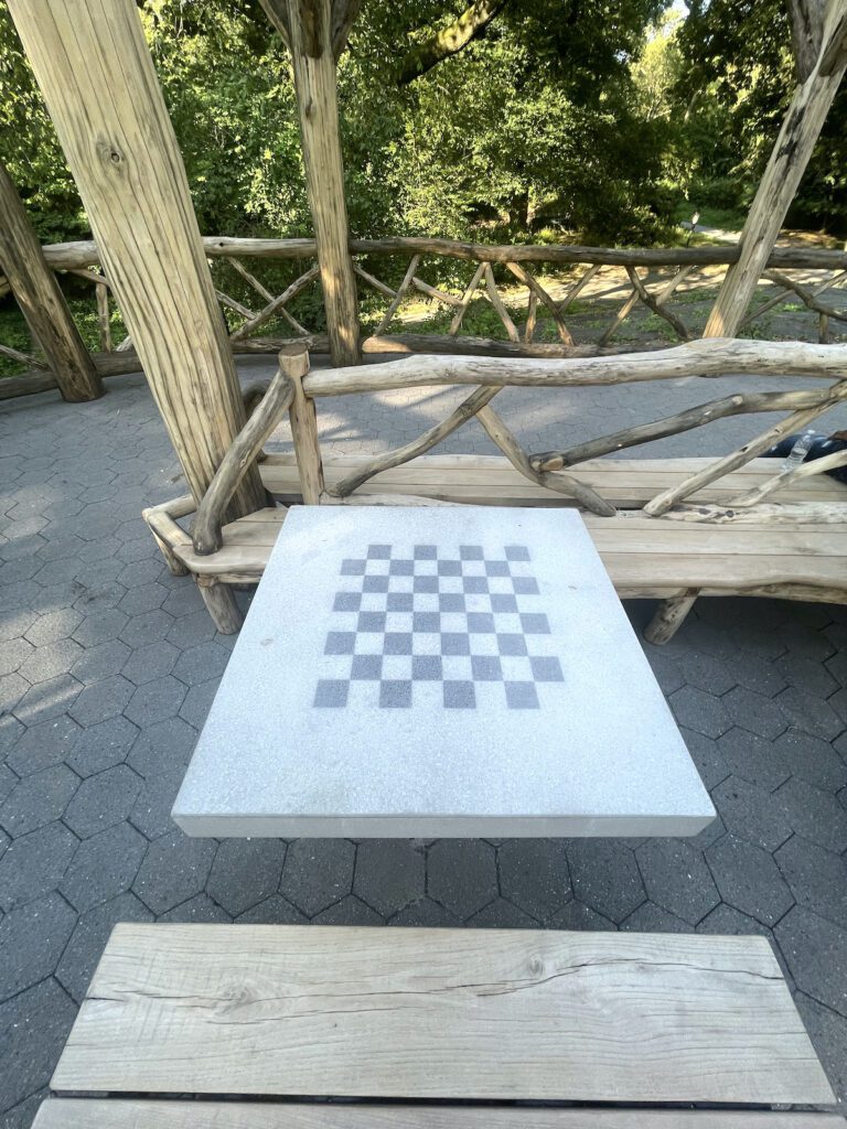 seat and chess board in central park | Better Together Here