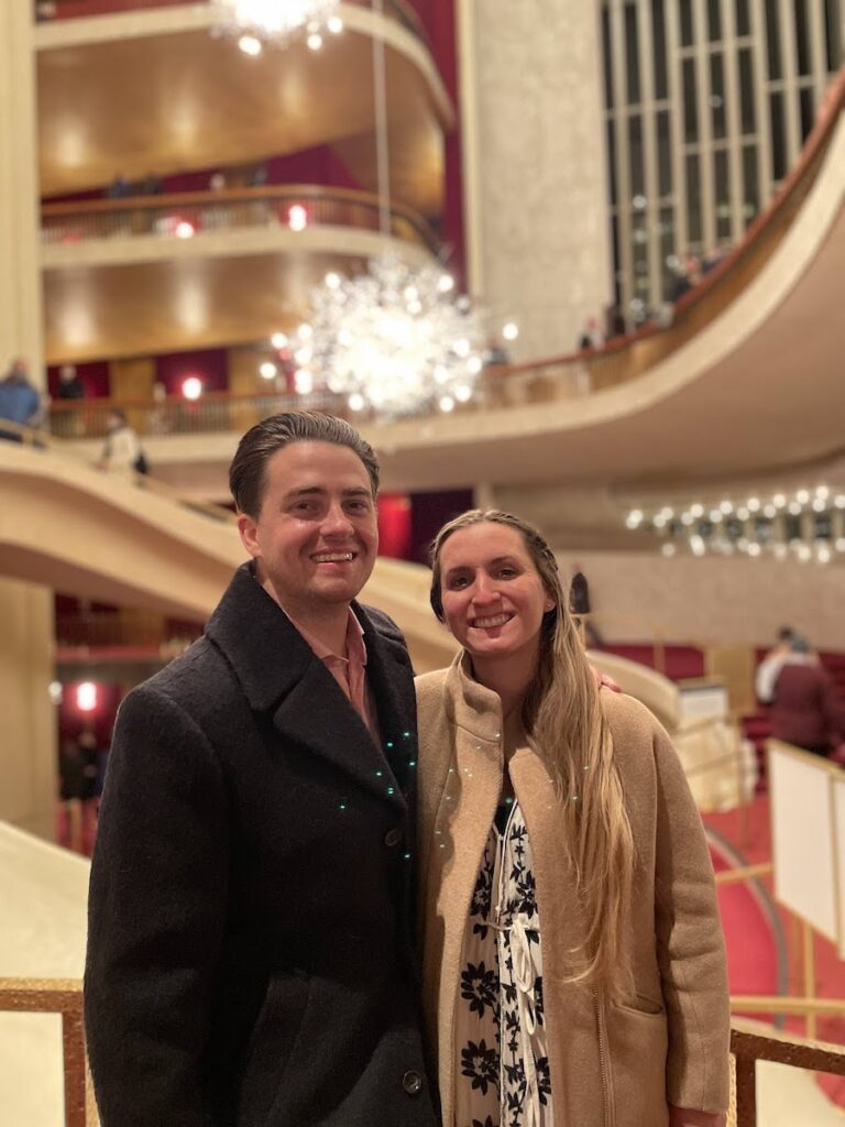couple standing in front of the chandelier at metropolitan opera house | Better Together Here