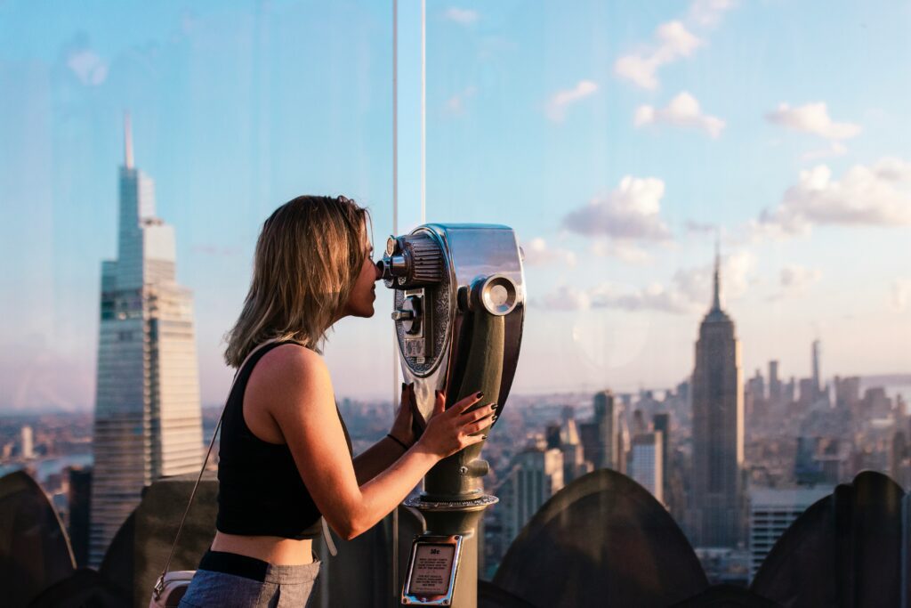 a woman on top of an observation deck that she purchased a ticket through the go city explorer pass | Better Together Here