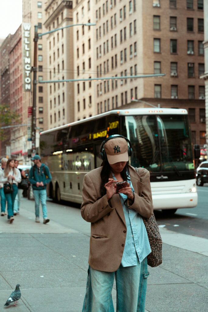 woman using the nyc citypass on her phone to book a ticket to the empire state building | Better Together Here